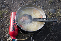 MSR camping stove being used to heat up noodles